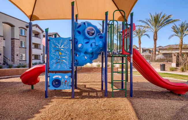 a playground with a slide and climbing equipment in a park
