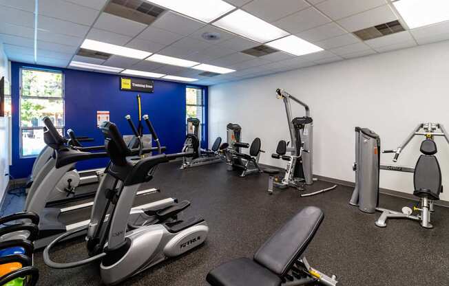 a gym with cardio equipment and weights in a health center