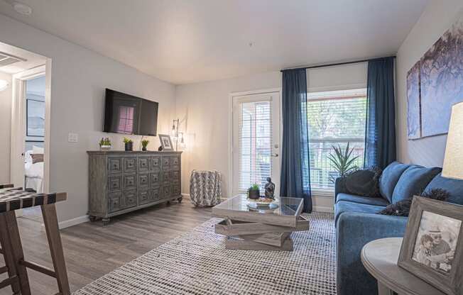 a living room with a blue couch and a tv