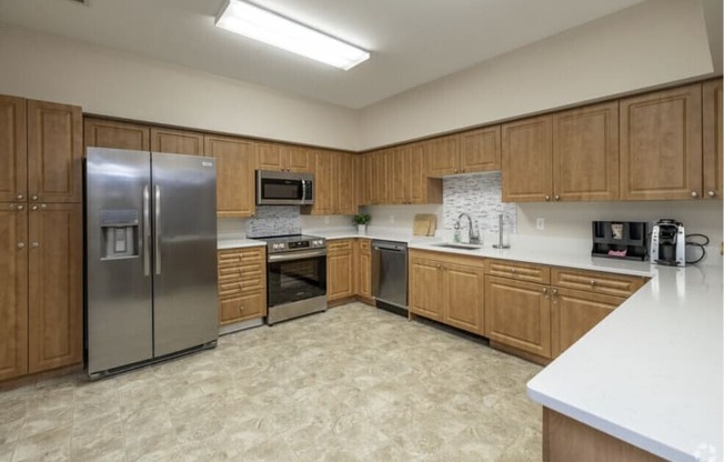 A kitchen with wooden cabinets and a tiled backsplash.