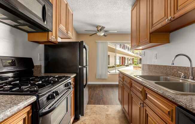 a kitchen with a stove top oven next to a sink