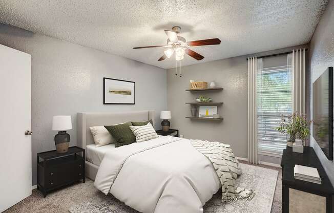 our apartments offer a bedroom with a large bed and a ceiling fan