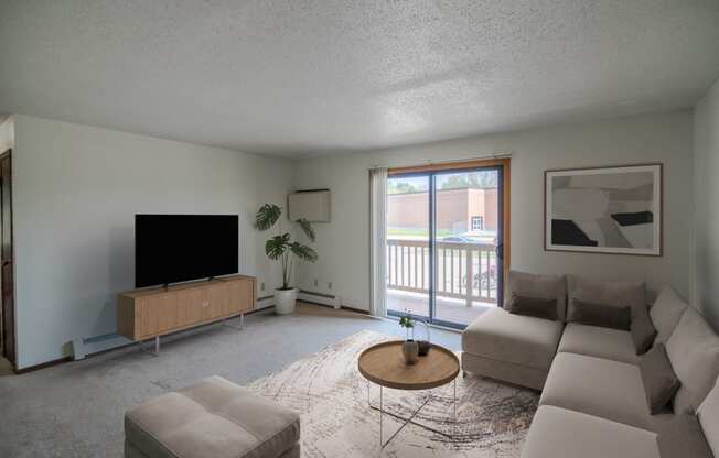 A living room with a couch and a coffee table. Bismarck, ND Eastbrook Apartments.