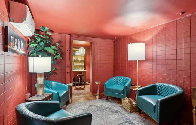 A room with red walls and blue chairs.