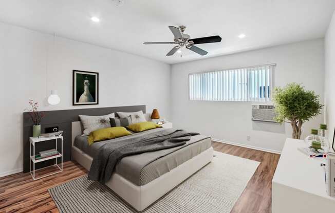 a bedroom with a bed and a ceiling fan