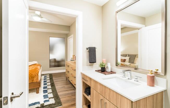 A clean-lined primary bath at Modera McGavock, offering warm finishes, generous storage, and a comfortable retreat just outside Nashville.