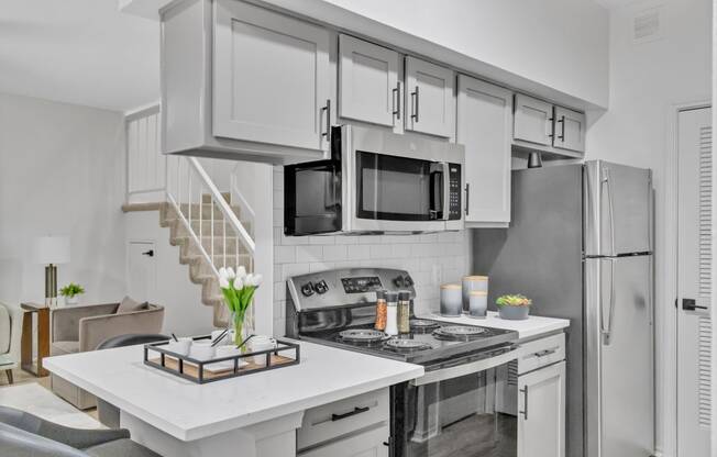 a kitchen with stainless steel appliances and a white counter top