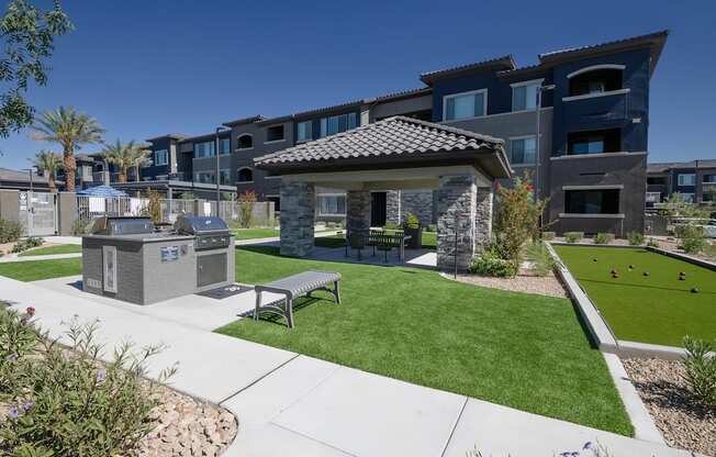 Community game area with bocce ball, benches, a ramada, BQQ area