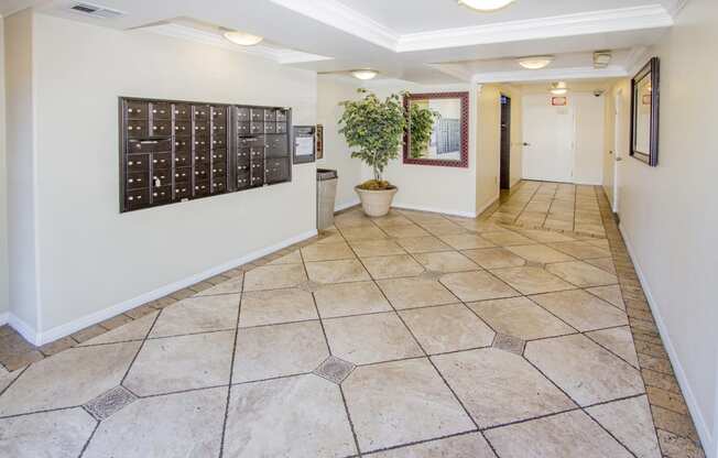 a hallway with tile floors and a calendar on the wall