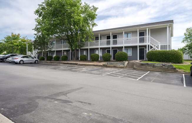 an empty parking lot in front of an apartment building