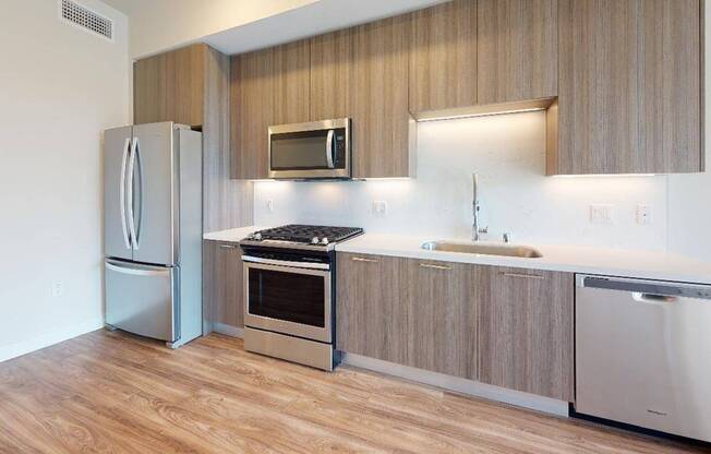 Stainless steel appliances and quartz countertops and backsplashes create a clean, modern look.