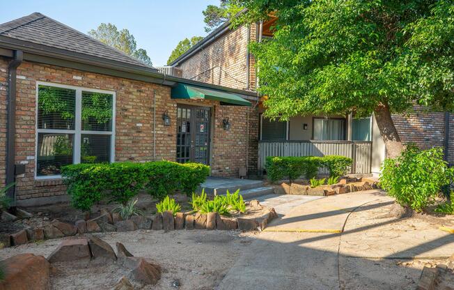 a stone path in front of a brick building