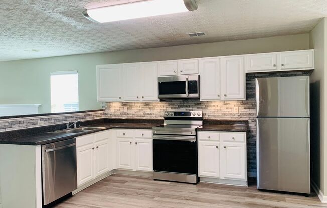 Prime location! 4 bed, 2.5 bath, LVP flooring, stainless appliances, ceiling fans, arched door ways, vaulted ceilings, must see!