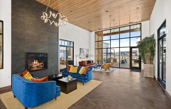 a living room with blue couches and a fireplace