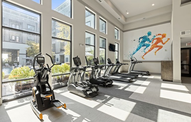 A gym with treadmills and exercise bikes.