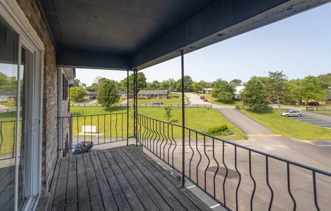 the view from the balcony of a residence with a wooden deck and balcony railings