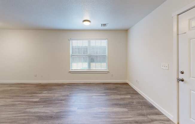 a bedroom with hardwood flooring and a window at Bennett Ridge Apartments, Oklahoma City, 73132