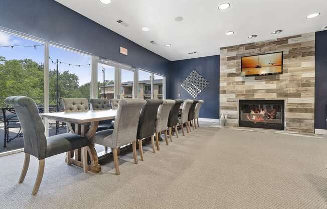 A modern dining room with a fireplace and a large table.