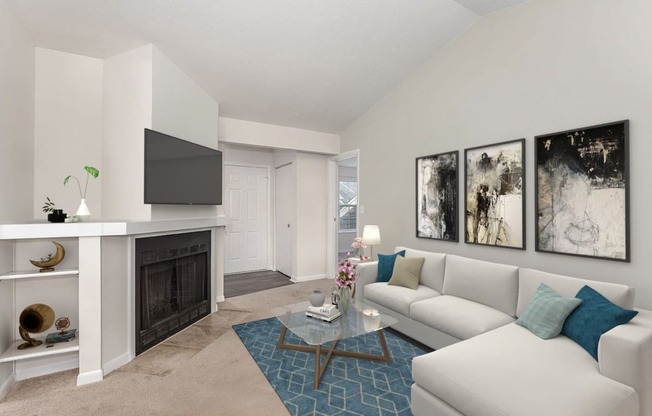 a living room with a white couch and a fireplace