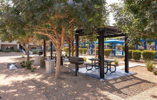 a group of tables and chairs in a park