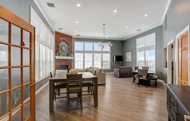 a dining room and living room with a table and chairs