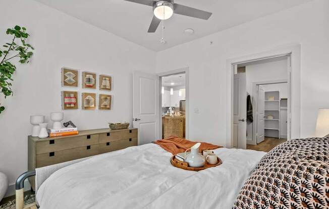 a bedroom with a bed and a ceiling fan