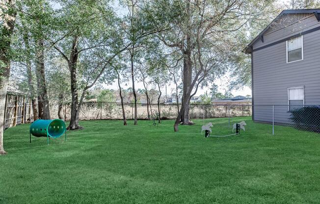 a large green field in front of a house