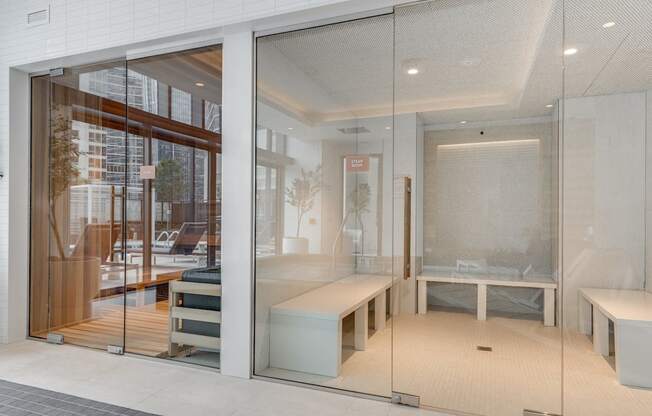 a glass walled room with a bed and a table at Cassidy on Canal, Chicago, IL