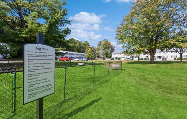 a dog park with a dog park rules sign in front of a fenceat Fox Hill Commons, Vernon, CT, 06066