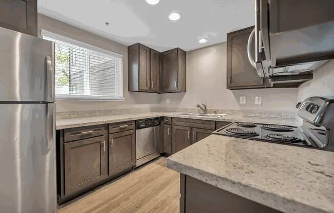 a kitchen with granite counter tops and stainless steel appliances