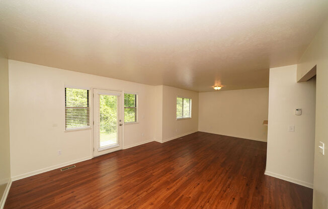 A living room with hard surface floors at Foxwood and The Hermitage, Portage, MI, 49024