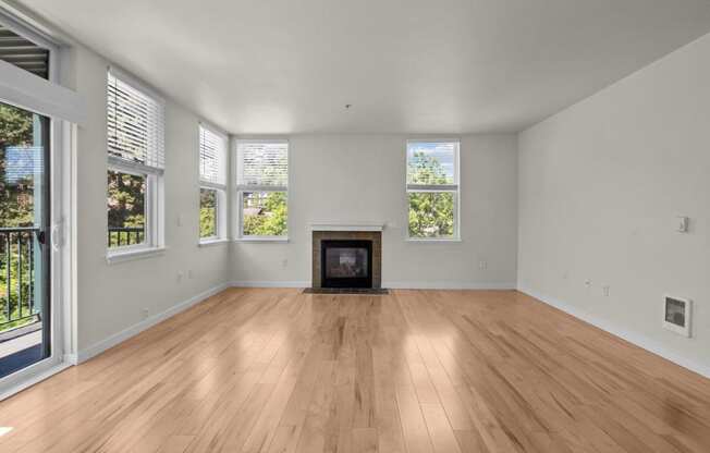 a living room with a fireplace and wooden floors