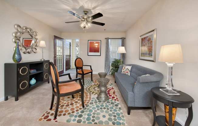 a living room with a couch and a ceiling fan