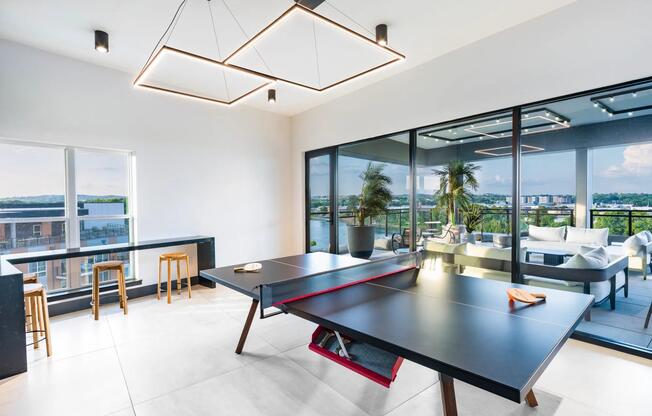 The sky lounge game room invites you to relax and take in sweeping skyline views—whether you're playing ping pong or unwinding on the terrace.