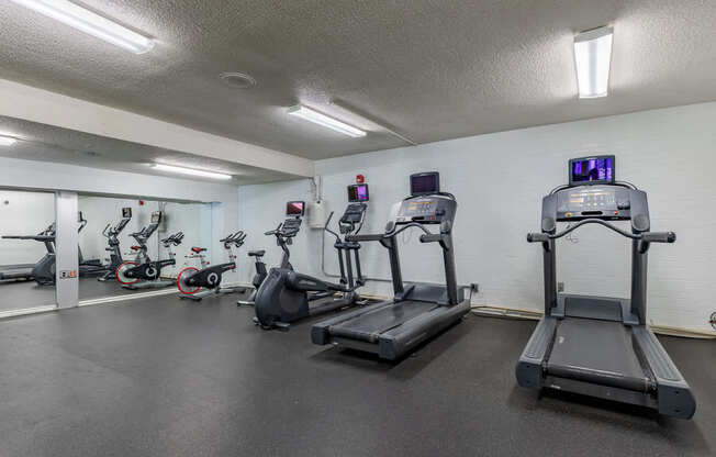 A gym with treadmills and exercise bikes.