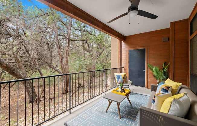 a balcony with a couch and a table