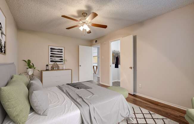 a bedroom with a bed and a ceiling fan