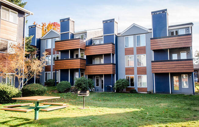 A large apartment complex with a picnic table in front. at Northpoint Apartments, Tacoma, 98407