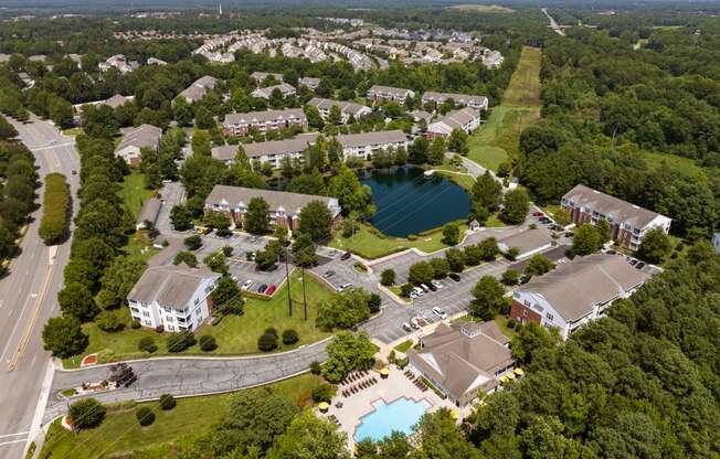 an aerial view of the campus with a lake in the middle