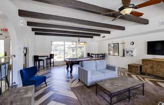 a living room with a couch and a pool table