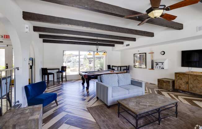 a living room with a couch and a pool table