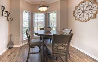 A dining room with a table and chairs.
