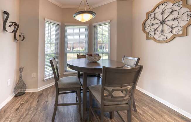 A dining room with a table and chairs.