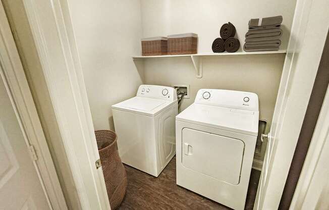 A small laundry room with a washer and dryer.