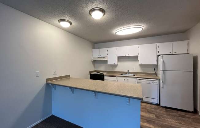 a kitchen with white cabinets and white appliances