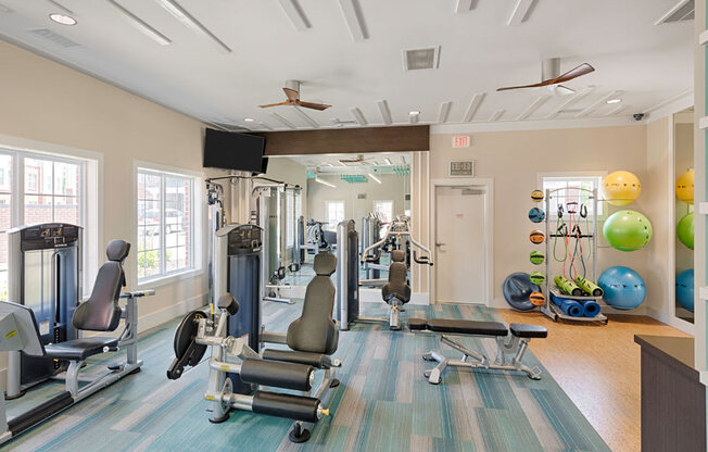 Fitness center with strength-training equipment; yoga area