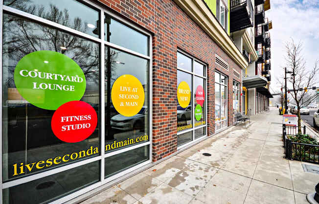 A storefront with a green sign that says Courtyard Lounge.