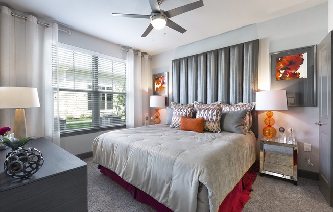 a bedroom with a large bed and a ceiling fan at North Creek, Texas