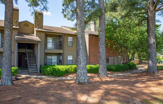 exterior view of the apartments with trees and a pathway at The Summit Apartments, Tennessee