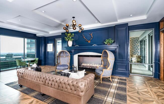 Gather fireside at Modera Old Ivy, where tailored interiors, skyline light, and inviting lounge seating create a refined setting in Atlanta.